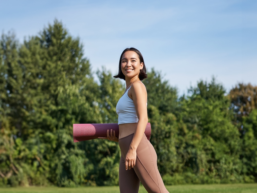 young woman with yoga mat